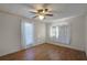 Bright bedroom with hardwood floors and two windows at 208 S Main Ave, Minneola, FL 34715