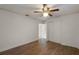 Bright bedroom with wood flooring, ceiling fan, and double closets at 208 S Main Ave, Minneola, FL 34715