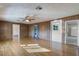 Living room with hardwood floors, wood paneling, and ceiling fan at 208 S Main Ave, Minneola, FL 34715