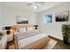 Light-filled bedroom with a wooden bed frame and ample floor space at 211 Palm Pl, Sanford, FL 32773