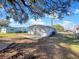 Rear view of house showing gray siding and large backyard space at 211 Palm Pl, Sanford, FL 32773