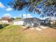 House exterior showcasing gray siding and a spacious backyard at 211 Palm Pl, Sanford, FL 32773