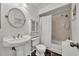 Clean bathroom featuring a pedestal sink, shower, and linen cabinet at 2419 Gallery View Dr # 10, Winter Park, FL 32792