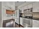 Modern kitchen with stainless steel appliances and dark hardwood floors at 2419 Gallery View Dr # 10, Winter Park, FL 32792