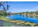 Serene lake view with lush landscaping and a water fountain at 2419 Gallery View Dr # 10, Winter Park, FL 32792