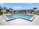 Community pool with lounge chairs and surrounding patio at 2419 Gallery View Dr # 10, Winter Park, FL 32792