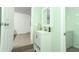 Guest bathroom with white vanity and view to laundry area at 2420 Musselwhite Ave, Orlando, FL 32804