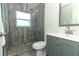 Updated bathroom with gray vanity and walk-in shower at 2420 Musselwhite Ave, Orlando, FL 32804