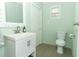 Updated bathroom with white vanity and mint green walls at 2420 Musselwhite Ave, Orlando, FL 32804