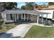 Charming one-story home with covered porch, carport, and well-manicured lawn at 2420 Musselwhite Ave, Orlando, FL 32804