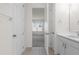 Bright bathroom features tile floors, white cabinets, and a glimpse into an adjacent room at 2438 Pearl Cider Street, Orlando, FL 32824