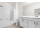 Clean bathroom with white cabinets, a bathtub, and shower at 2438 Pearl Cider Street, Orlando, FL 32824