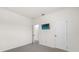 Simple bedroom with a mounted tv and access to other rooms at 2438 Pearl Cider Street, Orlando, FL 32824