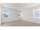 Sunlit bedroom with neutral carpet, three windows, and ample natural light at 2438 Pearl Cider Street, Orlando, FL 32824