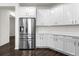 Modern kitchen with stainless steel appliances and white cabinets at 2438 Pearl Cider Street, Orlando, FL 32824