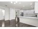 Modern kitchen with white cabinets, stainless steel appliances, and a large island at 2438 Pearl Cider Street, Orlando, FL 32824