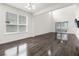 Bright living room features dark wood floors, a large window, and sliding glass doors for indoor-outdoor living at 2438 Pearl Cider Street, Orlando, FL 32824