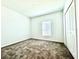 Spacious bedroom with neutral carpet and window with blinds at 245 Lawson Ave, Haines City, FL 33844