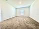 Spacious bedroom with neutral carpeting and large window at 245 Lawson Ave, Haines City, FL 33844