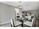 Bright dining room with glass table and modern light fixture at 2564 Sheffield Ave, Orlando, FL 32806