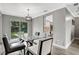 Dining room with glass table, grey walls, and backyard access at 2564 Sheffield Ave, Orlando, FL 32806