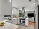 Modern kitchen with white cabinets, stainless steel appliances, and quartz countertops at 2564 Sheffield Ave, Orlando, FL 32806