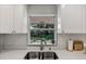 Kitchen sink and window overlooking a backyard garden at 2564 Sheffield Ave, Orlando, FL 32806