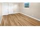 Bright bedroom featuring wood-look floors and ample closet space at 2569 Belmont Ave, New Smyrna Beach, FL 32168