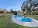 Inviting kidney-shaped pool surrounded by a grassy backyard at 2569 Belmont Ave, New Smyrna Beach, FL 32168