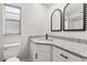 Bathroom with granite countertop, white cabinets, and black accents at 25753 Vero St, Sorrento, FL 32776