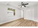 Light-filled bedroom featuring wood-look floors and a ceiling fan at 25753 Vero St, Sorrento, FL 32776