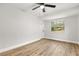 Bright bedroom with wood-look floors and ample closet space at 25753 Vero St, Sorrento, FL 32776