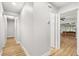 Bright hallway with light grey walls and wood-look floors at 25753 Vero St, Sorrento, FL 32776