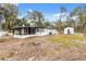 Rear view of house, showcasing the screened porch and yard at 25753 Vero St, Sorrento, FL 32776