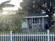 Gray house with white picket fence and tropical landscaping at 28 S Hastings St, Orlando, FL 32835