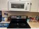 Kitchen features electric stovetop and microwave at 28 S Hastings St, Orlando, FL 32835