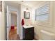 Simple bathroom with dark vanity and white toilet at 305 S Halifax Dr, Ormond Beach, FL 32176