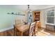 Bright dining room with hardwood floors and a view of the kitchen at 305 S Halifax Dr, Ormond Beach, FL 32176