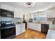 Bright kitchen with white cabinets and terracotta tile floors at 305 S Halifax Dr, Ormond Beach, FL 32176