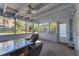 Screened porch with table and chairs at 305 S Halifax Dr, Ormond Beach, FL 32176