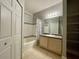 Bathroom with tub, vanity, and linen closet at 3250 Corona Village Way # 302, Orlando, FL 32835