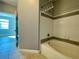 Bathroom with tub, shower, and grey tile at 3250 Corona Village Way # 302, Orlando, FL 32835