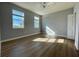 Bright bedroom with two windows, hardwood floors, and ceiling fan at 3250 Corona Village Way # 302, Orlando, FL 32835