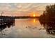Scenic sunset view over a lake with a pier at 3250 Corona Village Way # 302, Orlando, FL 32835