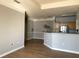 Open living room with hardwood floors and kitchen access at 3250 Corona Village Way # 302, Orlando, FL 32835