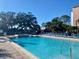 Inviting community pool with lounge chairs at 3250 Corona Village Way # 302, Orlando, FL 32835