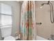 Bathroom featuring a vibrant shower curtain, tile shower and accessible grab bar at 3334 N Westmoreland Dr, Orlando, FL 32804