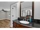 Bathroom vanity featuring a dark countertop, framed mirror and modern fixtures at 3334 N Westmoreland Dr, Orlando, FL 32804