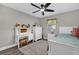 Bedroom featuring a desk and chair, dresser and closet with a ceiling fan and bright decor at 3334 N Westmoreland Dr, Orlando, FL 32804