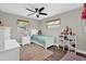 Bright bedroom with a ceiling fan, white furniture, and colorful curtains, creating a cozy and playful atmosphere at 3334 N Westmoreland Dr, Orlando, FL 32804